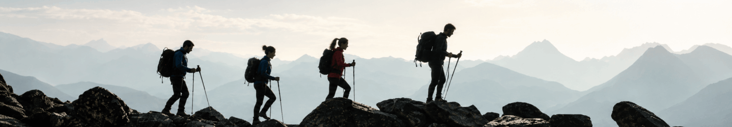 Four hikers walking on a mountain range